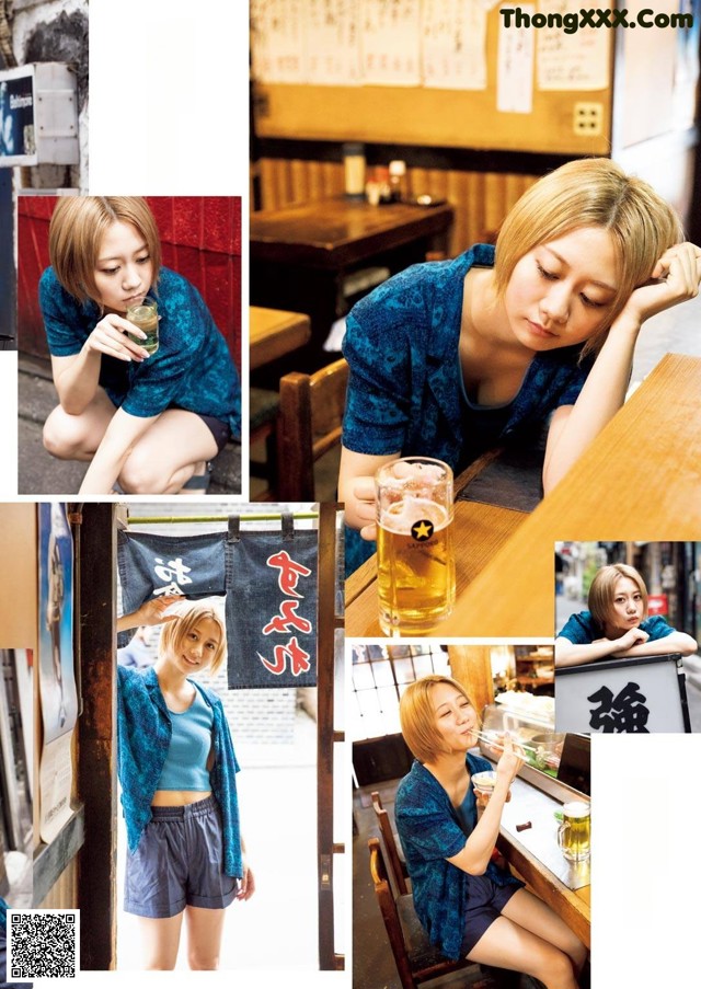 A woman sitting at a table with a glass of beer.