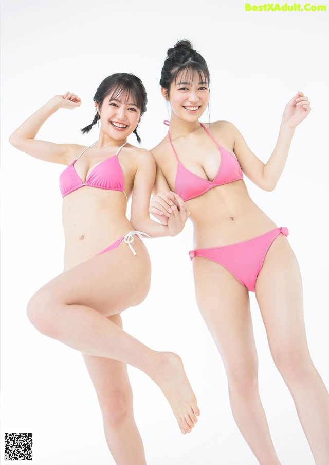 Two young women in pink bikinis posing for a picture.