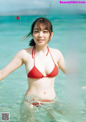 A woman in a white shirt is posing for a magazine.