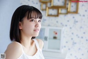 A woman sitting on top of a dresser with her feet up.