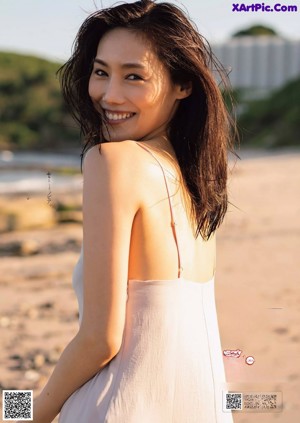 A woman in a black lingerie posing for a picture.