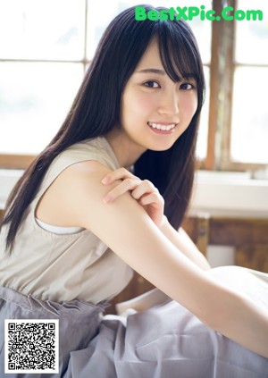 A magazine with a picture of a woman smiling.