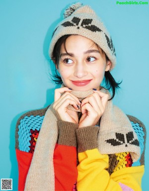 A woman wearing a necklace and earrings in a magazine.