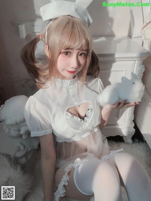 A woman in a bunny costume sitting on a toilet.