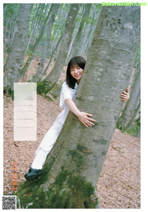 A woman laying on the ground next to a wall.