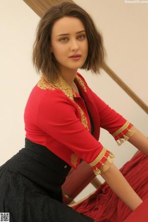 A woman in a black dress posing for the camera.