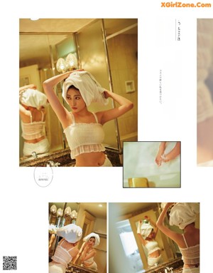 A woman in a white shirt and black shorts standing in front of a mirror.