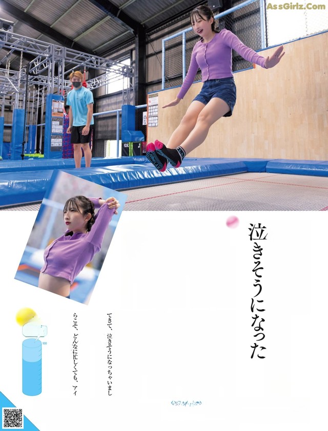 A woman jumping on a trampoline in a gymnasium. 