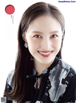 a woman in a black and white dress is posing for a magazine