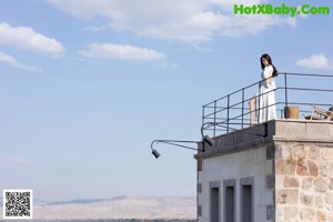 A woman in a black top and shorts is climbing up some stairs.