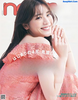 A woman in a red dress smiles at the camera.