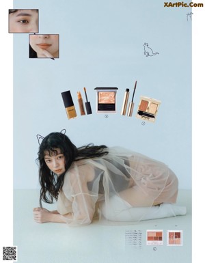 A magazine page with a woman laying on the ground.