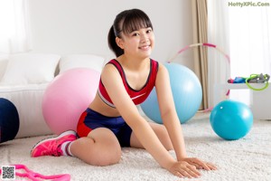 A woman standing on a balance board in a living room.