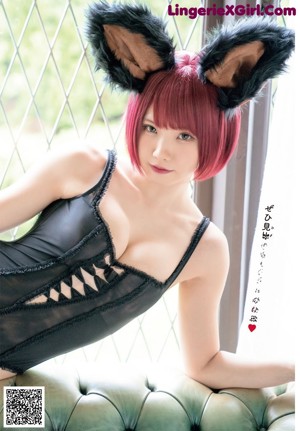 A woman with red hair wearing a black bra and bunny ears.