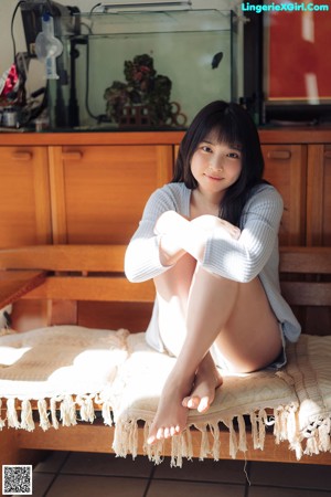 A woman laying on top of a wooden table.