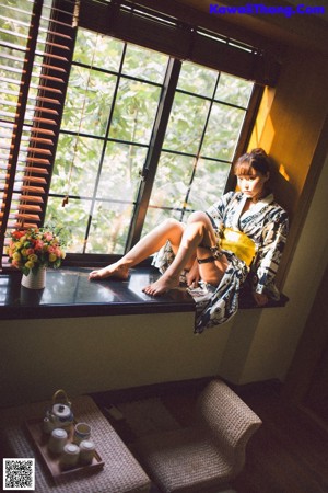 A woman in lingerie standing in front of a mirror.