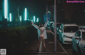 A person in a raincoat standing in the rain.
